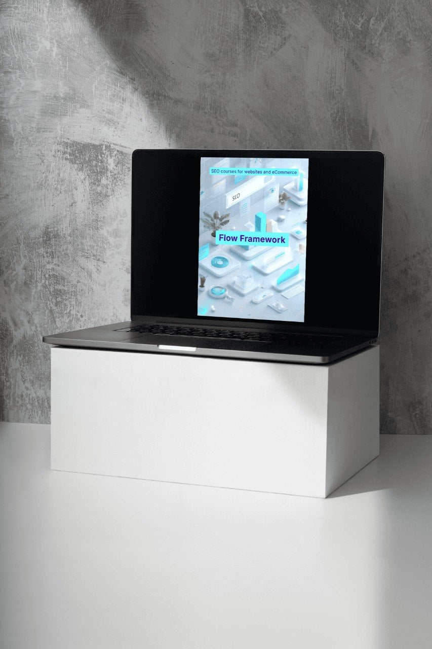 Laptop on a white stand with a concrete wall background