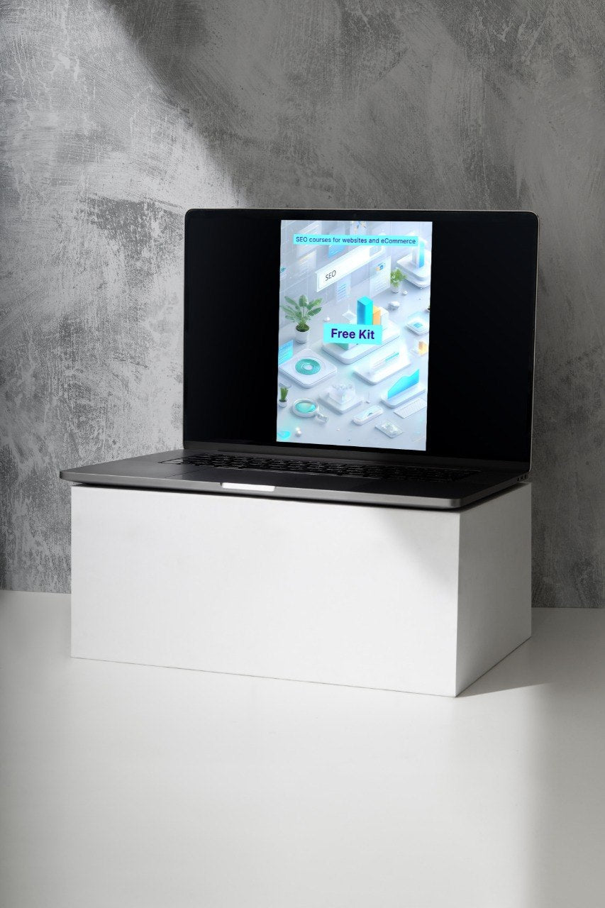 Laptop on a white stand with a concrete wall background